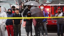 Onlookers gather at the site of a reported shooting outside the 36th Street subway station on April 12, 2022, in the Brooklyn neighborhood of Sunset Park in New York.