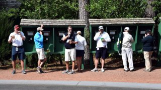 Patrons make phone calls during a practice round prior to the start of the 80th Masters of Tournament at the Augusta National Golf Club on April 6, 2016, in Augusta, Georgia. / AFP / Nicholas Kamm (Photo credit should read NICHOLAS KAMM/AFP via Getty Images)