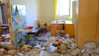 CHERNIHIV, UKRAINE – MAY 09: A healthcare professional searches for medicines and medical equipment in a destroyed hospital as Russian attacks continue in Chernihiv, Ukraine on May 09, 2022. Patients are treated in additional buildings as health services are disrupted due to the destroyed hospitals. (Photo by Abdullah Unver/Anadolu Agency via Getty Images)