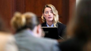 Actor Johnny Depp, left, listens as actor Amber Heard testifies in the courtroom at the Fairfax County Circuit Court in Fairfax, Va., Wednesday May 4, 2022.