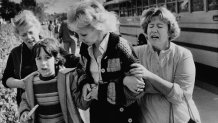 Unidentified women greet a young boy who was evacuated by bus to a nearby junior high school in San Diego from the schoolyard of the Cleveland Elementary School after a sniper opened fire on the schoolyard, Jan. 29, 1979.