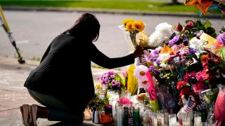 Shannon Waedell-Collins pays her respects at the scene of a mass shooting at a supermarket, in Buffalo, N.Y., May 18, 2022.