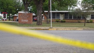 Sheriff crime scene tape is seen outside of Robb Elementary School as State troopers guard the area in Uvalde, Texas, on May 24, 2022. – An 18-year-old gunman killed 14 children and a teacher at an elementary school in Texas on Tuesday, according to the state’s governor, in the nation’s deadliest school shooting in years.