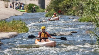 A person kayaks in the LA River.