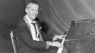 American rock and roll singer and musician Jerry Lee Lewis photgraphed sitting at his piano, 1958. *** Local Caption ***