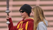 LOS ANGELES, CA - DECEMBER 5: Jake Olson and Emma Olson lead the Trojan Marching Band during the game between the Arizona Wildcats and the USC Trojans on December 5, 2009 at the Los Angeles Coliseum in Los Angeles, California. Jake was a guest of the team and is a huge USC fan who lost his eyesight to cancer. Arizona won 21-17. (Photo by Jeff Golden/Getty Images)