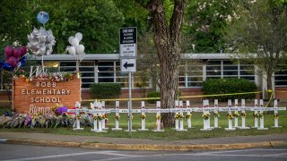 FILE - A memorial is seen outside Robb Elementary School after a mass shooting on May 26, 2022, in Uvalde, Texas.