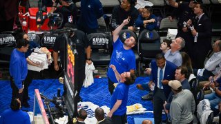 Members of the arena staff put down towels to absorb water from a leaking roof before the start of the third quarter between the Dallas Mavericks and the Golden State Warriors in game four of the 2022 Western Conference Finals.