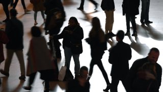 Silhouette’s of commuters and tourists as they make their way through Grand Central Terminal in New York City during the morning rush hour.