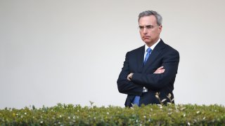 White House counsel Pat Cipollone listens as President Donald Trump speaks during a coronavirus task force briefing in the Rose Garden of the White House, Sunday, March 29, 2020, in Washington.