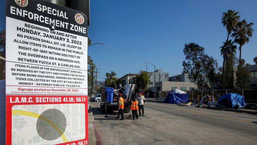 A homeless encampment special enforcement zone sign is pictured.