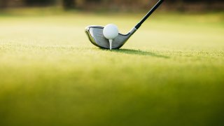 Close-Up Of Golf Ball On tee on a golf course – stock photo