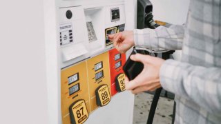 A man purchases gas at a pump in this undated photo.