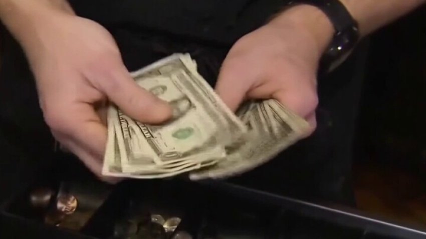 Person counting dollar bills.