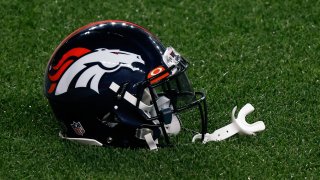 A Denver Broncos helmet on the ground before the game against the Tennessee Titans at Empower Field at Mile High.