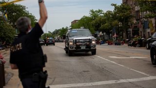 HIGHLAND PARK, IL – JULY 04: First responders work the scene of a shooting at a Fourth of July parade on July 4, 2022 in Highland Park, Illinois.