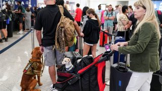 Passengers are seen at the Delta Air Lines check-in counters at Hartsfield-Jackson Atlanta International Airport ahead of the Fourth of July holiday in Atlanta, Georgia, July 1, 2022.