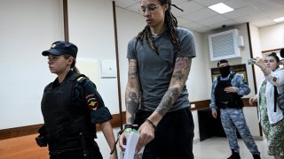 US’ Women’s National Basketball Association (NBA) basketball player Brittney Griner, who was detained at Moscow’s Sheremetyevo airport and later charged with illegal possession of cannabis, waits for the verdict inside a defendants’ cage before a court hearing in Khimki outside Moscow, on August 4, 2022. 