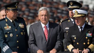 Mexican President Andres Manuel Lopez Obrador, flanked by Defense Secretary Gen. Luis Crescencio Sandoval, left, and Marine Secretary Jose Rafael Ojeda