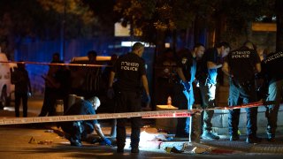 Israeli police crime scene investigators work at the scene of a shooting attack that wounded several Israelis near the Old City of Jerusalem