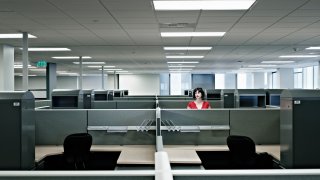 Businesswoman standing alone in empty office