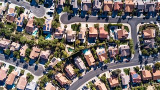 Top down aerial shot of suburban tract housing near Santa Clarita, California. A maze of roads and dead end streets of large single family homes, some with swimming pool.