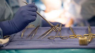 FILE - Surgical instruments are used during an organ transplant surgery