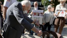 FILE - Demonstrators watch as former Cardinal Theodore McCarrick leaves Dedham District Court after his arraignment, Friday, Sept. 3, 2021, in Dedham, Mass. McCarrick has pleaded not guilty to sexually assaulting a 16-year-old boy during a wedding reception in Massachusetts nearly 50 years ago. (AP Photo/Michael Dwyer, File)