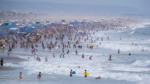 Huntington Beach, CA - September 04: Thousands of beach-goers flock to the beach and the cool ocean waters to escape the heat wave on Labor Day weekend in Huntington Beach Sunday, Sept. 4, 2022. (Allen J. Schaben / Los Angeles Times via Getty Images)