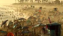 HUNTINGTON BEACH, CALIF. - SEP. 5, 2022. People crowd the beach as fog drifts ashore at sunset at Huntington Beach on Monday, Sep. 5, 2022. (Luis Sinco / Los Angeles Times via Getty Images)