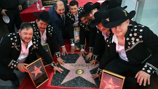 Members of Norteno musical group Los Huracanes Del Norte pose for a photo during a ceremony to unveil their Hollywood Walk of Fame Star.