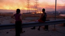 CASTAIC, CALIFORNIA - AUGUST 31: Residents who were evacuated from their home watch as the Route Fire burns on August 31, 2022 near Castaic, California. Evacuations have been ordered as the brush fire has scorched more than 4,600 acres and closed down the 5 freeway at the start of a brutal heat wave in Southern California. The National Weather Service issued an Excessive Heat Warning for most of Southern California through Labor Day. Climate models almost unanimously predict that heat waves will become more intense and frequent as the planet continues to warm. (Photo by Mario Tama/Getty Images)