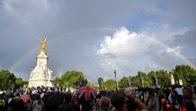 A rainbow fills the sky outside of Buckingham Palace