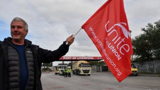 A striking dockworker on a picket line outside the Port of Liverpool during a strike in Liverpool, UK, on Tuesday, Sept. 20, 2022.