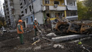 Municipality workers clean debris at Zestafoni Street in Zaporizhzhia, Ukraine, on Oct. 25, 2022.