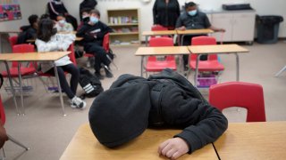 student rests on his desk