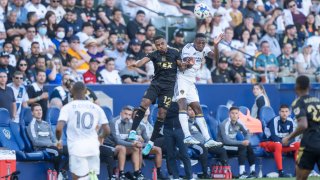 Two players collide in a soccer match between LAFC and the LA Galaxy.