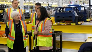 US Treasury Secretary Janet Yellen tours the Ford Motor Company’s Rouge Electric Vehicle Center that builds the all-electric Ford F-150 Lightning with Linda Zhang,(R), chief engineer for the vehicle, before delivering an economic speech in Dearborn, Michigan, on September 8, 2022.