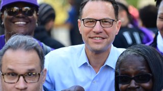 (C) Democratic candidate for Governor Pennsylvania Attorney General Josh Shapiro poses with supporters following a joint rally with Democratic candidate for U.S. Senate John Fetterman at Norris Park on October 15, 2022 in Philadelphia, Pennsylvania.