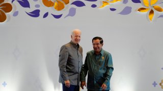 U.S. President Joe Biden, left, is greeted by Cambodia's Prime Minister Hun Sen