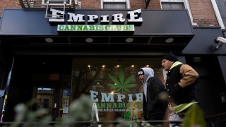 People walk past the Empire Cannabis Club