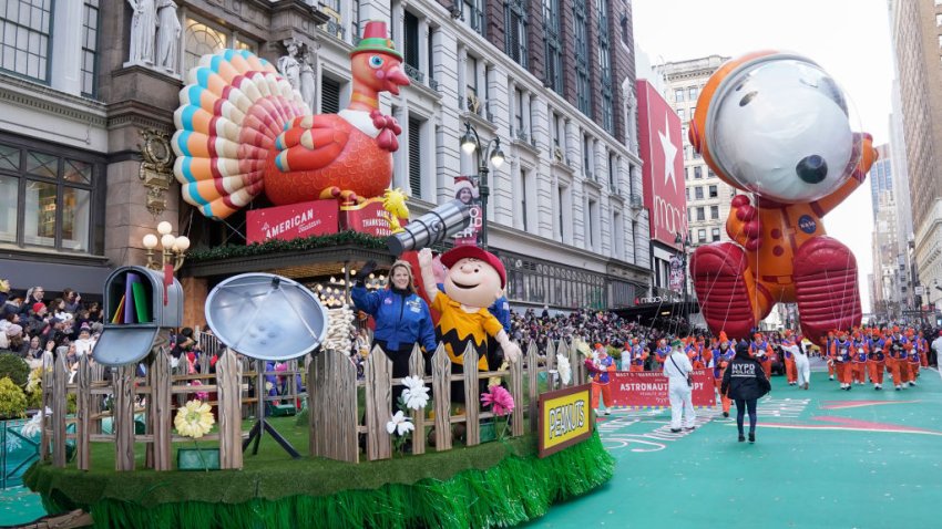 A turkey float is followed by a giant "Astronaut Snoopy" balloon at the Macy's Thanksgiving Parade.