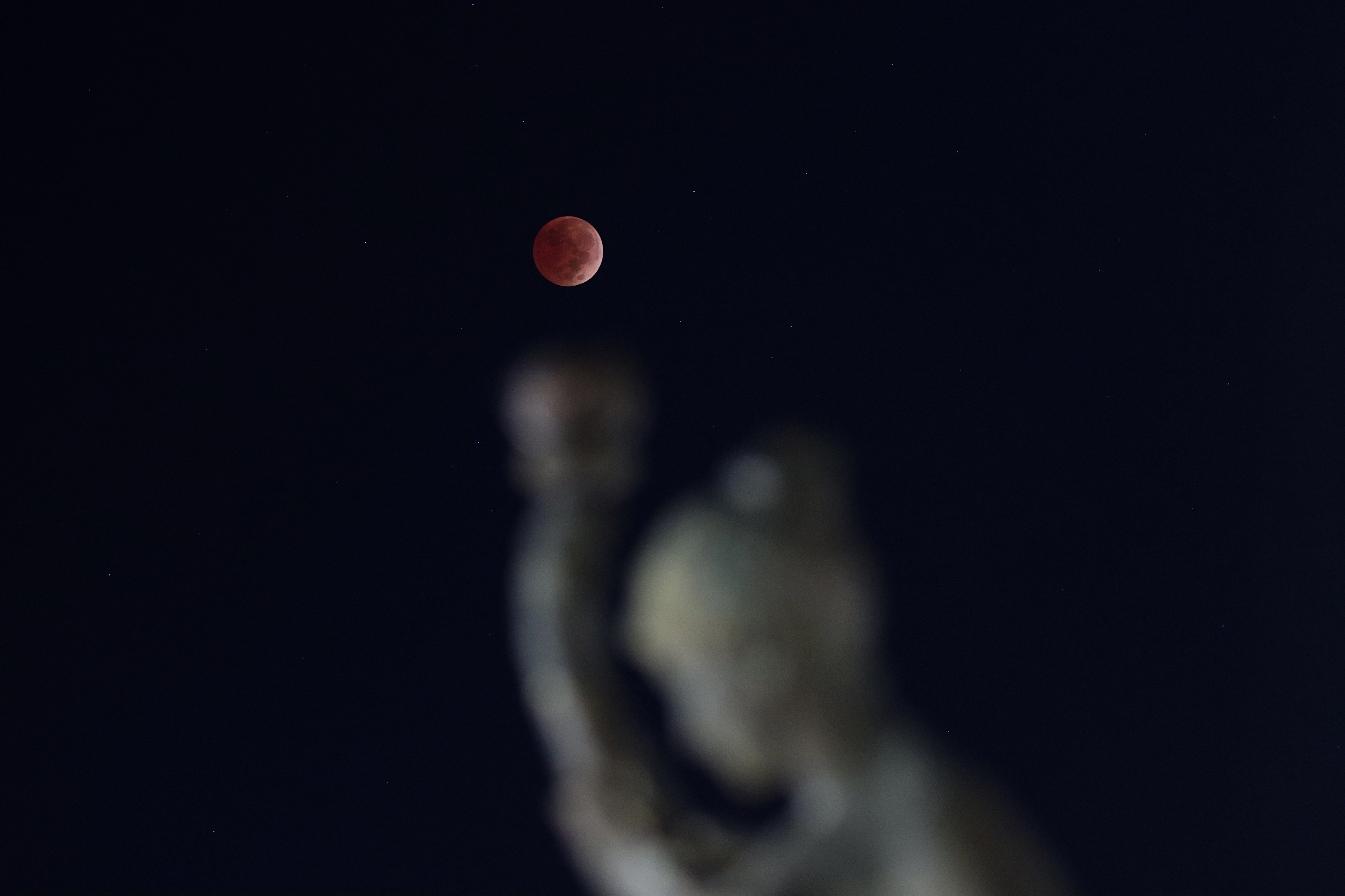 The blood-red full Beaver Moon passes behind a monument, Nov. 8, 2022, in Saltillo, Coahuila, Mexico.