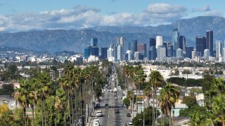 A clear view of downtown LA looking north along Avalon Boulevard in South Los Angeles.