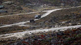 An Indian Army truck drives along a road to Tawang, near the Line of Actual Control neighboring China in India’s Arunachal Pradesh state on Oct. 21, 2021.