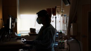 FILE - A registered nurse works on a computer