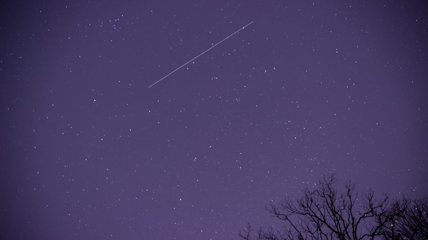 FILE - A meteor streaks across the night sky in Nashville, Tennessee, as the Geminid meteor shower reached its maximum in the early morning of Dec. 14, 2021.