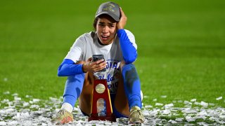 Maricarmen Reyes of the UCLA Bruins sits on the field.