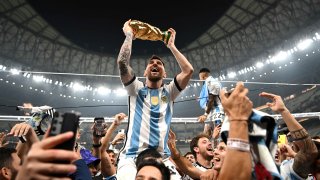 Lionel Messi of Argentina celebrates with the World Cup Trophy after winning the FIFA World Cup Qatar 2022 Final match between Argentina and France at Lusail Stadium on December 18, 2022 in Lusail City, Qatar.