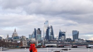 People walk along Waterloo Bridge past the City of London skyline, the capital’s financial district. U.K.-focused equity funds saw record outflows in 2022.